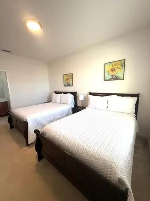 a room with two beds in a room at Lakeview Home Sleeps 25 VPR103 in Kissimmee