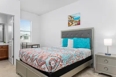 a bedroom with a king sized bed and a window at Lakeview Home Sleeps 25 VPR103 in Kissimmee