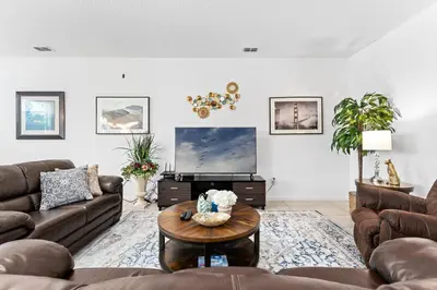 a living room with couches and a coffee table at Lakeview Home Sleeps 25 VPR103 in Kissimmee