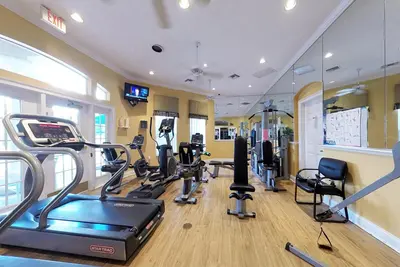 a gym with treadmills and cardio equipment in a room at A Peaceful Orlando Escape, nature, comfort & Disney Nearby EMI101 in Kissimmee