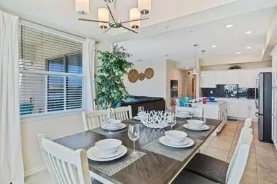 a dining room and kitchen with a table and chairs at 3141 Paradox Circle 406 in Kissimmee