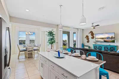 a kitchen and living room with a couch and a table at 3141 Paradox Circle 406 in Kissimmee