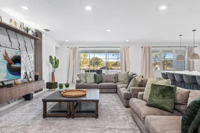 a living room with a couch and a table at Unique Masterpiece 15 En-suites VPR104 in Kissimmee