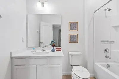 a white bathroom with a toilet and a sink at Unique Masterpiece 15 En-suites VPR104 in Kissimmee