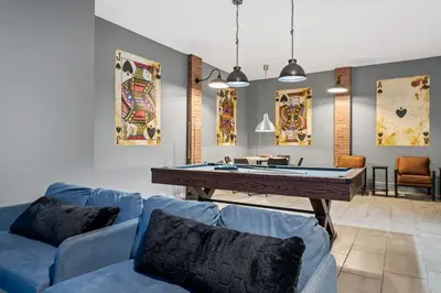a living room with a pool table and blue couches at Unique Masterpiece 15 En-suites VPR104 in Kissimmee