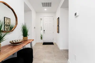 a hallway with a table and a mirror at Brand New Masterpiece 15 En-Suites SON105 in Kissimmee