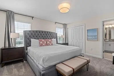 a bedroom with a large bed and a window at Comfy Townhome 8 Min to Disney STL120 in Kissimmee