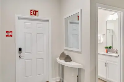 a bathroom with a white door and a sink at Private Pool 8 Min to Disney STL121 in Kissimmee