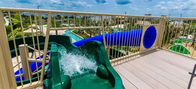 a water slide on a balcony at a resort at Private Pool 8 Min to Disney STL121 in Kissimmee