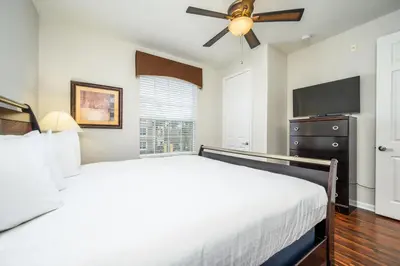 a bedroom with two beds and a ceiling fan at Epic Universe Premium Lake View Condo, Vista Cay - 1002 in Orlando