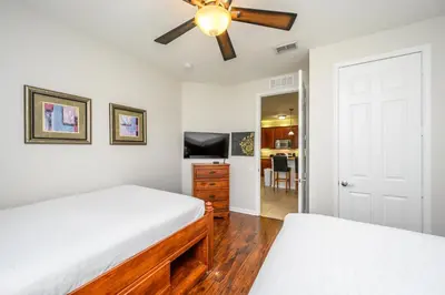 a bedroom with two beds and a ceiling fan at Epic Universe Premium Lake View Condo, Vista Cay - 1002 in Orlando
