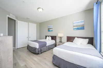 a hotel room with two beds and a window at Beautiful Lake View Condo, Vista Cay-1004 in Orlando