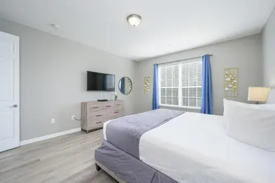 a bedroom with a large bed and a window at Beautiful Lake View Condo, Vista Cay-1004 in Orlando