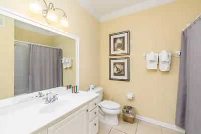 a bathroom with a sink and a toilet and a mirror at Gorgeous 3 Bed Lakeview, Vista Cay - 1010 in Orlando