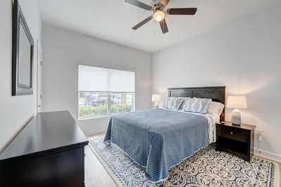 a bedroom with a bed and a ceiling fan at This Happy Place in Kissimmee