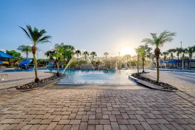 a resort with palm trees and a swimming pool at This Happy Place in Kissimmee