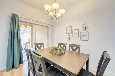 a dining room with a wooden table and chairs at This Happy Place in Kissimmee