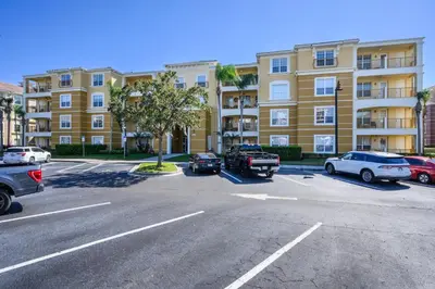 a parking lot with cars parked in front of a building at Beautiful Lakeview Condo, New Listing -1024 in Orlando