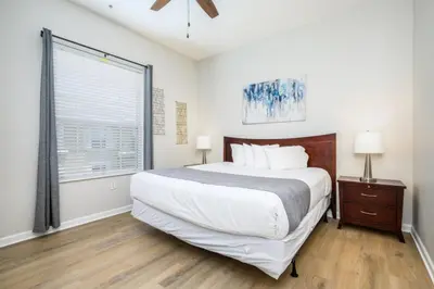 a bedroom with a large bed and a window at Epic Universe Penthouse Vacation Condo, Near The Parks - 2014 in Orlando