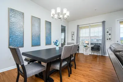 a dining room with a table and chairs and a couch at Penthouse Vacation Condo, Near The Parks - 2015 in Orlando