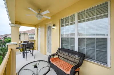 a balcony with a bench and a table and chairs at Penthouse Vacation Condo, Near The Parks - 2015 in Orlando