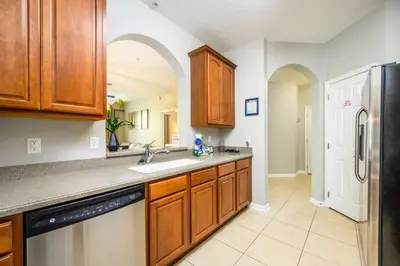 a kitchen with a sink and a refrigerator at Vista Cay Deluxe Condo, Near The Parks! - 3002 in Orlando