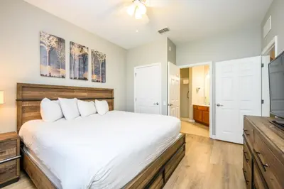 a bedroom with a large bed and a flat screen tv at Vista Cay Deluxe Condo, Near The Parks! - 3002 in Orlando