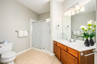 a bathroom with a toilet and a sink and a shower at Vista Cay Deluxe Condo, Near The Parks! - 3002 in Orlando
