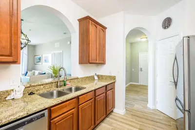 a kitchen with a sink and a refrigerator at Beautiful Deluxe Condo, Vista Cay, Orlando - 3008 in Orlando