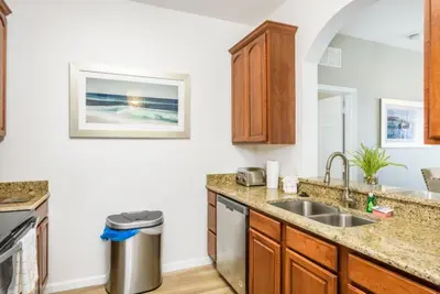 a kitchen with a sink and a counter at Beautiful Deluxe Condo, Vista Cay, Orlando - 3008 in Orlando