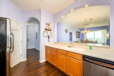 a kitchen with a sink and a refrigerator at Vista Cay Deluxe Condo, Vista Cay - 3010 in Orlando