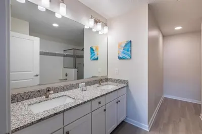a bathroom with two sinks and a large mirror at New Modern Vista Cay Reserve Condo - 6007 in Orlando
