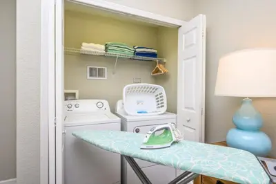 a laundry room with a washing machine and a table at Epic Universe New Modern Townhome, Near The Parks - 4029 in Orlando