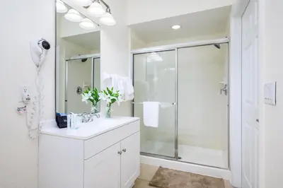 a white bathroom with a shower and a sink at New Listing, Beautiful Townhome, Vista Cay - 4014 in Orlando