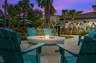 a group of chairs and a fire pit in a patio at New Modern Vista Cay Reserve Condo - 6006 in Orlando