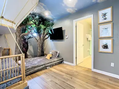 a room with a tree mural on the wall at WH7820BS - 5 bedrooms - Pool - Theater - Resort in Orlando
