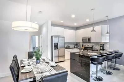 a kitchen with a table and chairs and a refrigerator at Pond view pool home close to Disney TR17508PA - 3 bedrooms - 3 bath - waterview in Orlando