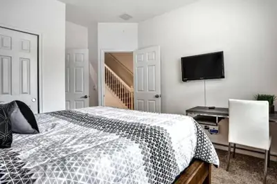 a bedroom with a bed and a flat screen tv at Pond view pool home close to Disney TR17508PA - 3 bedrooms - 3 bath - waterview in Orlando