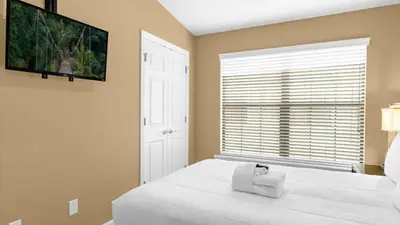 a bedroom with a large white bed and a window at Ultimate Summer Retreat - TownHome by Disney! in Orlando