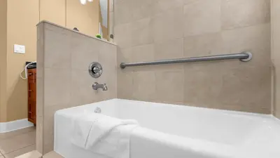 a bathroom with a bath tub with a towel on it at Ultimate Summer Retreat - TownHome by Disney! in Orlando