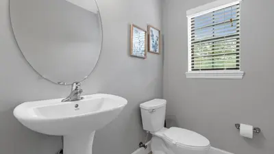 a white bathroom with a sink and a mirror at Book Your Summer Escape - TownHome by Disney! in Orlando