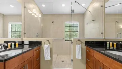 a large bathroom with two sinks and a shower at Book Your Summer Escape - TownHome by Disney! in Orlando