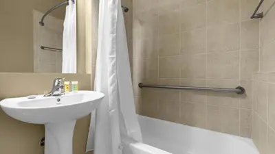 a bathroom with a sink and a toilet and a shower at Book Your Summer Escape - TownHome by Disney! in Orlando
