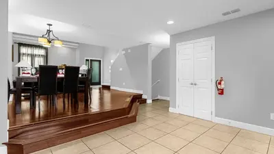 a dining room and living room with a table and chairs at Sunny Summer in Orlando - TownHome by Disney! in Orlando