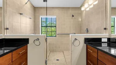 a bathroom with a shower with a glass door at Sunny Summer in Orlando - TownHome by Disney! in Orlando