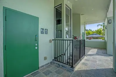 a hallway with a green door in a house at Sunny Summer in Orlando - TownHome by Disney! in Orlando