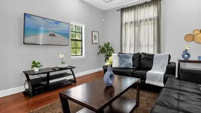 a living room with a couch and a table at Sunny Summer in Orlando - TownHome by Disney! in Orlando