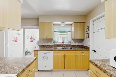 a kitchen with wooden cabinets and a sink at Pool Access! Dog-Friendly Retreat 16 Mi to Orlando in Orlando