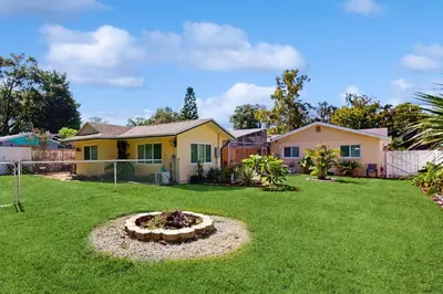a house with a yard with a fire pit at Pool Access! Dog-Friendly Retreat 16 Mi to Orlando in Orlando