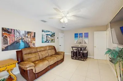 a living room with a couch and a table at Pool Access! Dog-Friendly Retreat 16 Mi to Orlando in Orlando